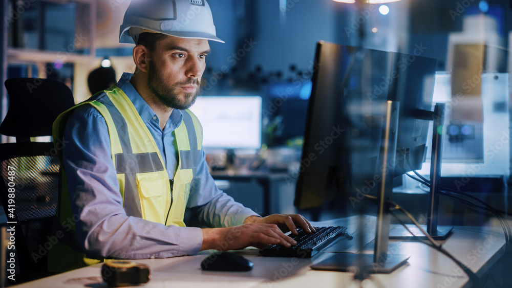 Poster electronics design factory: portrait of handsome male engineer wearing safety vest working on comput