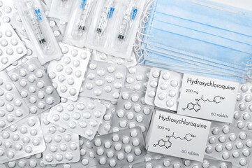 Hydroxychloroquine as possible treatment for coronavirus. Tablets in boxes and blister with medical...