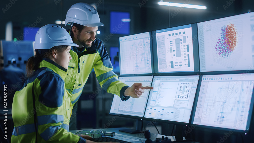 Aufkleber Industry 4.0 Modern Factory: Chief Project Manager Talks to Female Engineer, She Points at Computer Screens Showing Complex Industrial Electronics Design Blueprints, They Have Find Problem Solution