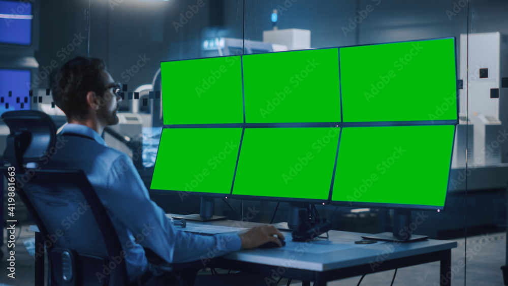 Poster Industry 4.0 Modern Factory: Security Operator Controls Proper Functioning of Workshop Production Line, Uses Computer with 6 Screens Showing Green Screen Mock up Template.