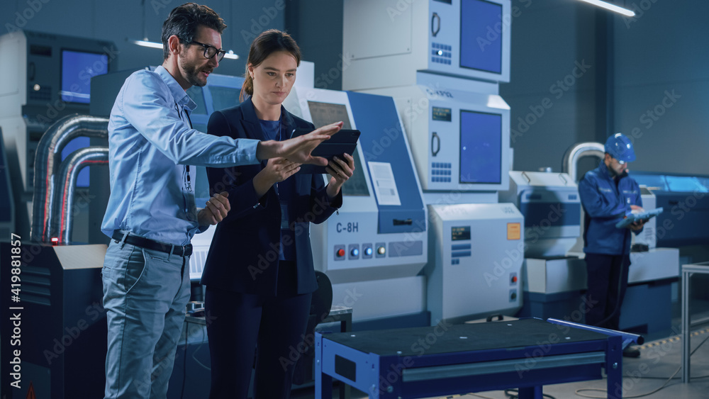 Poster Portrait of Two Professional Engineers Use Industrial Digital Tablet to Work with Augmented Reality. Great Template Shot for Augmented Reality. Factory Workshop with CNC Machinery.