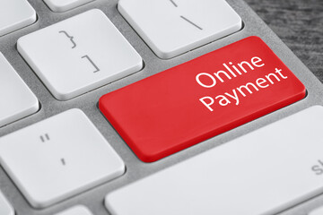 Fototapeta premium Modern laptop keyboard with text Online Payment on red button, closeup view