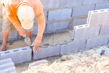 Workers are laying blocks of bricks.