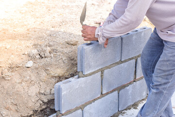 Workers are laying blocks of bricks.