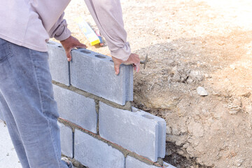 Workers are laying blocks of bricks.