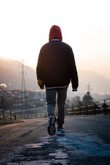 person walking towards the cold sunrise