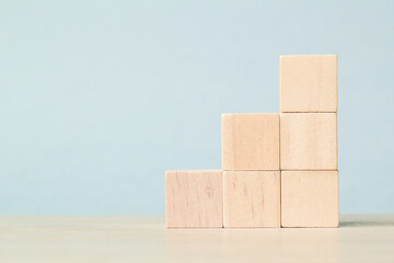 Stack wooden blocks on a blue background