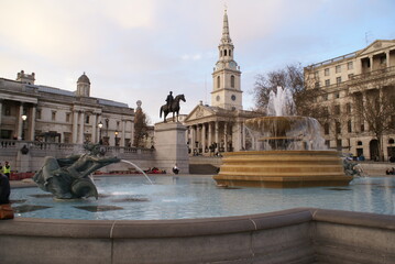 London, UK: fountain in Trafalgar square, with view of the National Gallery and St Martin-in-the-Fields in the background