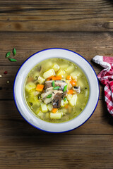 Ukha, canned fish soup on wooden rustic background. Space for text, top view.