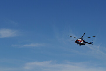 Fototapeta na wymiar Helicopter in a blue sky. Russia, Murmansk.