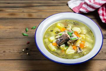 Country living, healthy meal, fish soup on wooden rustic background. Space for text.