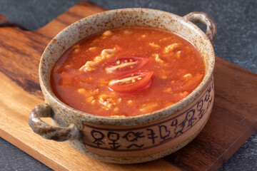 Tomato Soup with Chicken in a Cup on a Black Table