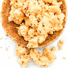 Scrambled eggs on toasted bread with black pepper