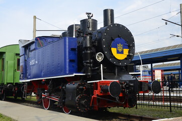 Retro steam locomotive stands at the station