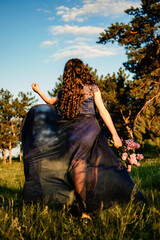 Party graduation prom fairytale concept. Beautiful brunette young woman in blue prom dress with...