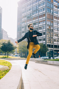 young caucasian bearded businesslike man jumping outdoor