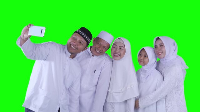 Happy muslim family taking selfie photo on studio