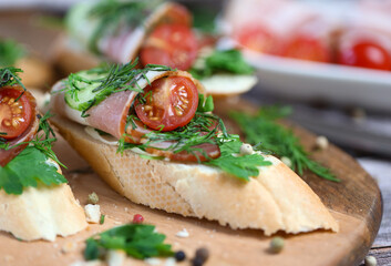 bruschetta with bacon, cherry tomatoes, cucumbers and herbs, Mediterranean food 