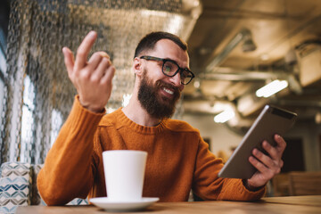 Man gesticulating while having video call
