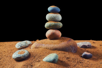 Balanced stack of zen rocks on sand