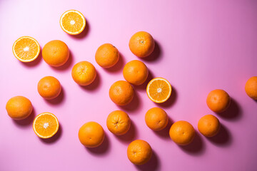 Fototapeta na wymiar various oranges on an exotic background. oranges on a pink background