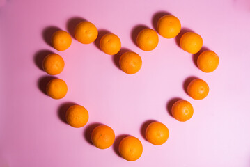 various oranges on an exotic background.oranges on a pink background
