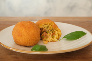 Fried arancino balls meat sauce peas and basil, traditional italian food