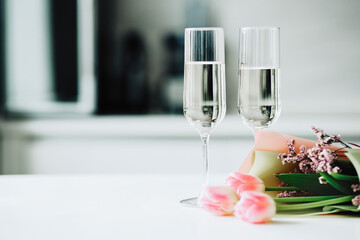 Two glasses and a tulips bouquet, mother's day, holiday at home