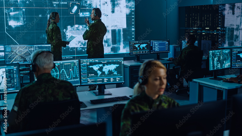 Poster Military Surveillance Team of Officers Locked a Target on a Vehicle from a Satellite and Monitor it on a Big Display in Office for Cyber Operations for Managing Security and Army Communications. 