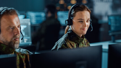 Military Surveillance Team of Officers in Headsets Working in a Central Office Hub for Cyber Operations, Control and Monitoring for Managing National Security, Technology and Army Communications.