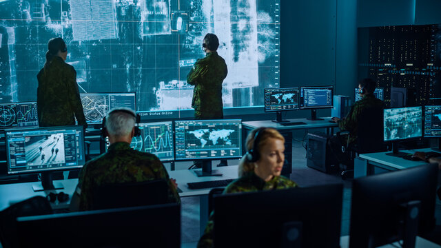 Military Surveillance Team of Officers Locked a Target on a Vehicle from a Satellite and Monitor it on a Big Display in Office for Cyber Operations for Managing Security and Army Communications. 
