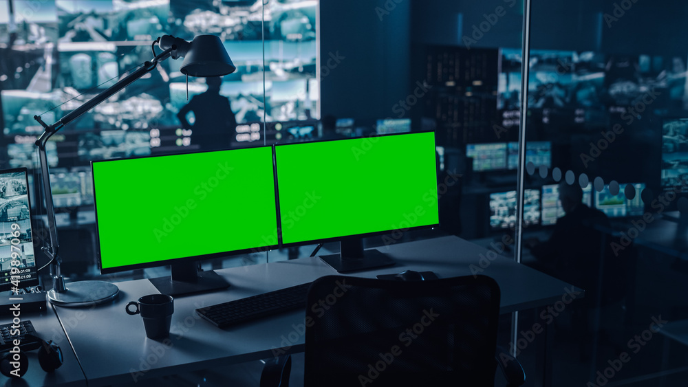 Aufkleber Two Digital Computer Screens with a Green Mock Up Chromakey in Modern Monitoring Office. Control Room with Specialists and Managers Sit in Front of Computers. 