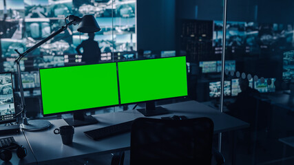 Two Digital Computer Screens with a Green Mock Up Chromakey in Modern Monitoring Office. Control...