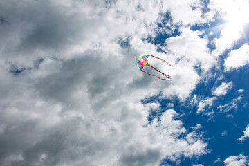 A kite flying in the sky with clouds