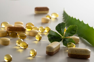 A group of food additives diffrent shape and colors with green leaf on  white background. As a concept of natural medicines. Preventive medicine. Prevention of coronovirus.