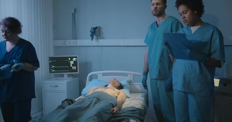 Young male patient dying in emergency room surrounded by medical team - Powered by Adobe