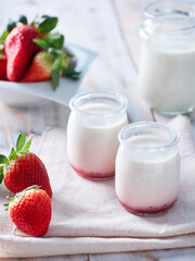 natural yogurt with fresh strawberries and glass of milk