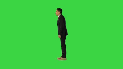Spanish businessman waving his hand and greeting someone and walks away on a Green Screen, Chroma Key.