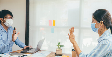 Asian People Successful Teamwork Business Wearing Medical Mask and Working. Work from Private Office Social Distancing among Coronavirus Outbreak Situation