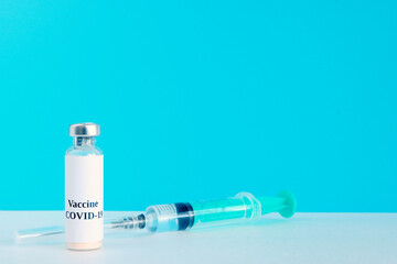 Vaccination concept. Medical instrument on a light background. Coronavirus vaccine vial and syringes