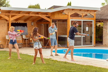 Friends having a squirt guns war