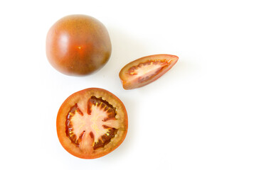 Group of fresh ripe red tomatoes, sliced and whole, isolated on white background.