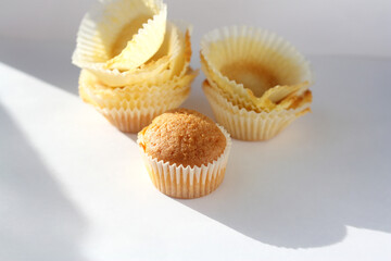 Homemade muffin packed in paper form. High-calorie confectionery. Sweet pastries for breakfast