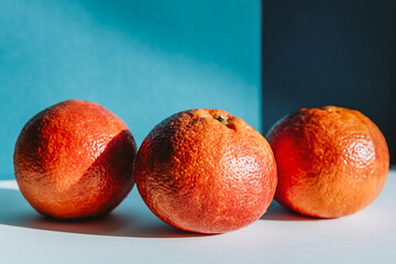 Fototapeta na wymiar sicilian and Moroccan ripe oranges on a colored background 