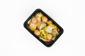 Top view of meatball in vegetable soup in black box isolate in white.