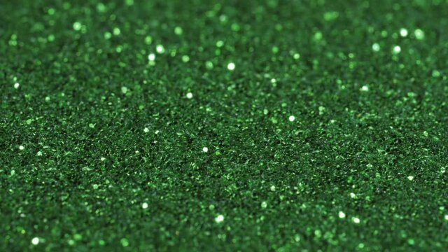 Macro slide shot, small green sequins, shimmer in the light