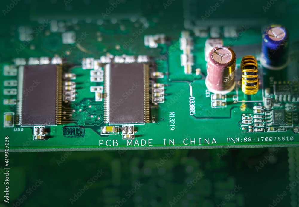 Poster made in china mark on a printed circuit board close-up. fragment of graphic card, electronic device.