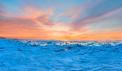 Fototapeta premium Beautiful landscape cracking ice, frozen norwegian sea coast at sunrise - Tromso, Norway