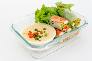 Fresh spring roll and egg steam dipping sauce in glass contain bowl isolate in white.