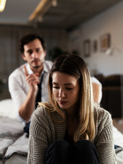 Husband and wife are arguing at home. Angry man is yelling at his wife.